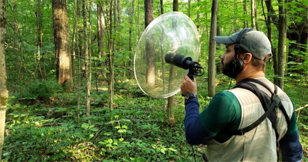 field-scientist-uses-audio-equipment-to-record-animal-communications-in-a-dense-forest-christan-kromme-speaker-futurist
